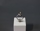 Ring in 14 ct. whitegold with large diamond, 1,8 ct., clarity P1, color 
grey/Brown along with smaller 0,4 ct. diamonds.
5000m2 showroom.