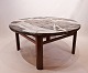 Large round coffee table with stone plate and frame of rosewood, danish design 
from the 1960s.
5000m2 showroom.
