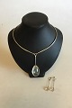 Georg Jensen Sterling Silver Set consisting of Neck Ring No 114 with Pendant of 
Rutil Quartz No 131 and associated Earrings with Screw lock. Designed by 
Vivianna Torun Bülow-Hübe