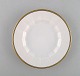 Royal Copenhagen. Three porcelain plates with gold border.
