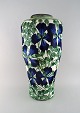 Early colossal Alumina vase in faience. Blue flowers and green leaves on cream 
colored background. Early 20th century.

