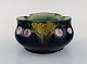 Antique Höganäs art nouveau bowl in glazed ceramics. Pink cherries on dark blue 
background. Early 20th century.
