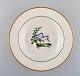 Royal Copenhagen soup plate in hand-painted porcelain with bird motifs and gold 
decoration. Early 20th century. 17 pcs in stock.
