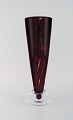 Liselotte Henriksen for Pukeberg. Large unique vase in dark red and clear mouth 
blown art glass. Dated 1987.
