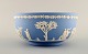 Wedgwood, England. Large bowl in light blue stoneware with classicist scenes in 
white. Approx. 1930.
