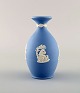 Wedgwood, England. Small vase in light blue stoneware with classicist scenes in 
white. Approx. 1930.
