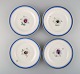 Four antique Royal Copenhagen plates in hand-painted porcelain with flowers and 
blue border with gold. Model number 592/9052. Late 19th century.
