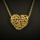 Georg Jensen; A necklace of 18k gold, heart set with a ruby