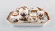 Helene Wolfson for Dresden. Tête-à-tête tea set in hand-painted porcelain with 
merchants and gold decoration. 19th century.
