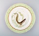 Royal Copenhagen fish plate with green edge, gold decoration and fish motif. 
Model 919/1710.
