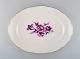 Antique oval Meissen serving dish in hand-painted porcelain with purple flowers 
and gold edge. Ca. 1900.
