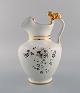 Antique Gustafsberg chocolate jug in porcelain modeled with a lion on the 
handle. Hand-painted flowers and gold decoration. Late 19th century.
