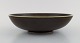 Round Rörstrand bowl in glazed ceramics. Beautiful glaze in brown shades. 
Mid-20th century.
