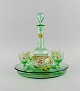 Legras, France. Cabarat Cigogne liqueur set in green mouth-blown art glass with 
hand-painted flowers. Approx. 1900.
