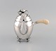 L'Art presents: Georg Jensen Blossom coffee pot in hammered sterling silver with ivory handle. Model 2C. Dated ...