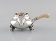Georg Jensen Blossom creamer in hammered sterling silver with ivory handle. 
Model 2C. Dated 1915-1930.
