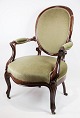 A neo-rococo armchair in mahogany with brand green velor upholstery from around 
the 1880s.
Dimensions in cm: 95 W: 59 D: 57 SH: 40
