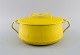 Jens H. Quistgaard (1919-2008), Denmark. Lidded pot in bright yellow enamel. 
1960s.
