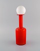 Otto Brauer for Holmegaard. Vase / bottle in red mouth-blown art glass with 
white ball. 1960