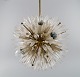 Emil Stejnar for Rupert Nikoll. Impressive ceiling lamp in brass and art glass 
shaped like crystals and flowers. Mid-20th century.

