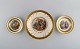 Three Royal Copenhagen bowls decorated with flowers and romantic scenery. Gold 
decoration. Mid-20th century.
