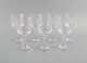Seven René Lalique Chenonceaux white wine glasses in clear mouth-blown crystal 
glass. Mid-20th century.
