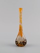 Daum Nancy, France. Art nouveau Prunellier vase in frosted mouth-blown art glass 
with orange leaves and black berries in relief. Approx. 1900.
