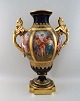 Wien, Austria. Colossal porcelain decorative vase with hand-painted classicist 
motifs and gold decoration. Handles modeled as mythological creatures. Ca. 1900.
