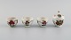 Antique Chinese lidded jar and three cups in hand-painted porcelain with 
flowers. 19th century.
