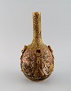 L'Art presents: Meiji (1868–1912). Japanese satsuma bottle vase decorated in colors and gold with flowers in ...
