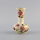 Zsolnay vase in cream-colored porcelain with hand-painted flowers, butterflies 
and gold decoration. Late 20th century.

