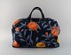 Josef Frank for Svenskt Tenn. Colorful bag with floral motifs. Handles and lock 
in leather and wood. 1970