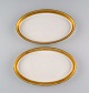 Royal Copenhagen service no. 607. Two oval porcelain dishes. Gold border with 
foliage. Model number 607/9499. Dated 1944.
