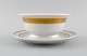 Royal Copenhagen service no. 607. Porcelain sauce bowl. Gold border with 
foliage. Model number 607/9580. Dated 1944.
