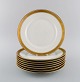 Royal Copenhagen service no. 607. Eight porcelain dinner plates. Gold border 
with foliage. Model number 607/9586. Dated 1944.
