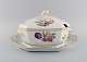 Royal Copenhagen Saxon Flower special version. Large and rare lidded tureen with 
saucer. Lid and handles modeled as foliage. Hand painted flowers and gold 
decoration. Approx. 1900.
