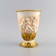 Capodimonte, Italy. Antique porcelain vase with putti in relief and hand-painted 
gold decoration. Early 20th century.
