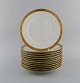Royal Copenhagen service no. 607. Twelve porcelain dinner plates. Gold border 
with foliage. Model number 607/9586. Dated 1960