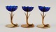 Gunnar Ander for Ystad Metall. Two candlesticks in brass and blue art glass 
shaped like flowers.
1950s.