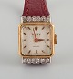 L'Art presents: Rolex, Precision. 18 carat gold ladies' wristwatch set with twelve diamonds.