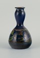Kähler vase with blue glaze and motif of flowers and branches.