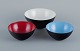 Three bowls in metal.
Blue, red and white.