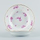 Royal Copenhagen, two deep plates hand painted with purple flowers and gold rim.