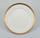 Royal Copenhagen no. 607. Round serving dish in porcelain.
Gold border with foliage.