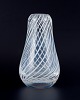 Skandinavian glass artist. Mouth-blown art glass vase in clear glass designed 
with white lines.