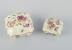 Zsolnay, Hungary, two lidded jars in porcelain hand-painted with flower motifs 
and insects on a cream-colored background.
