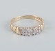 8 karat gold ring with numerous small diamonds in a modernist design.