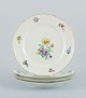 Bing & Grøndahl, Saxon Flower, a set of four dinner plates hand-decorated with 
polychrome flowers and gold rim.