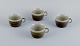 Marianne Westman for Rörstrand, "Maya", a set of four coffee cups in stoneware 
with green-brown glaze.