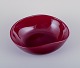 Monica Bratt for Reijmyre, Sweden. Large oval bowl in mouth-blown wine red art 
glass.